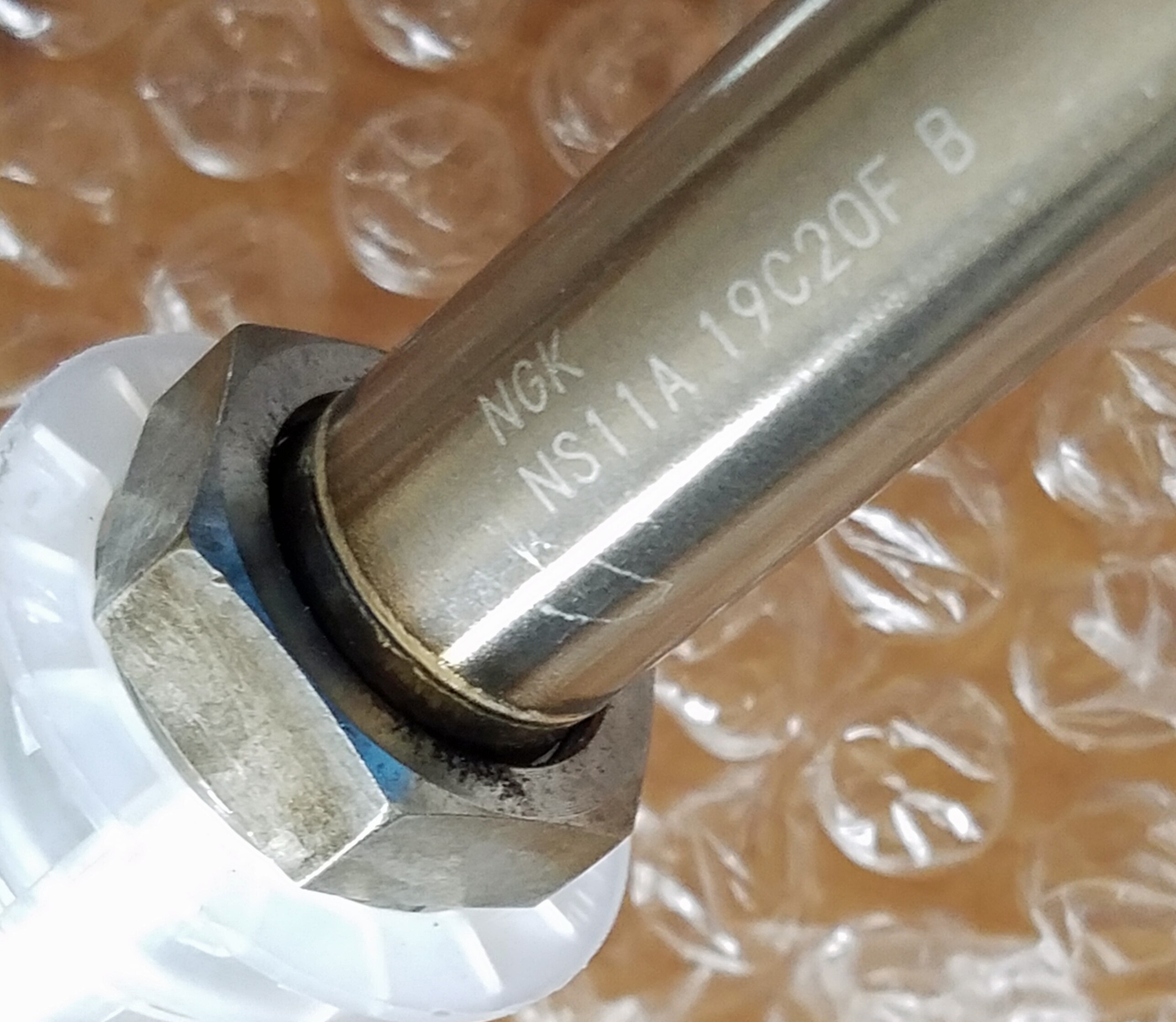 A photograph of the section of a Skyline OE manufactured NOx sensor that has the NGK marking